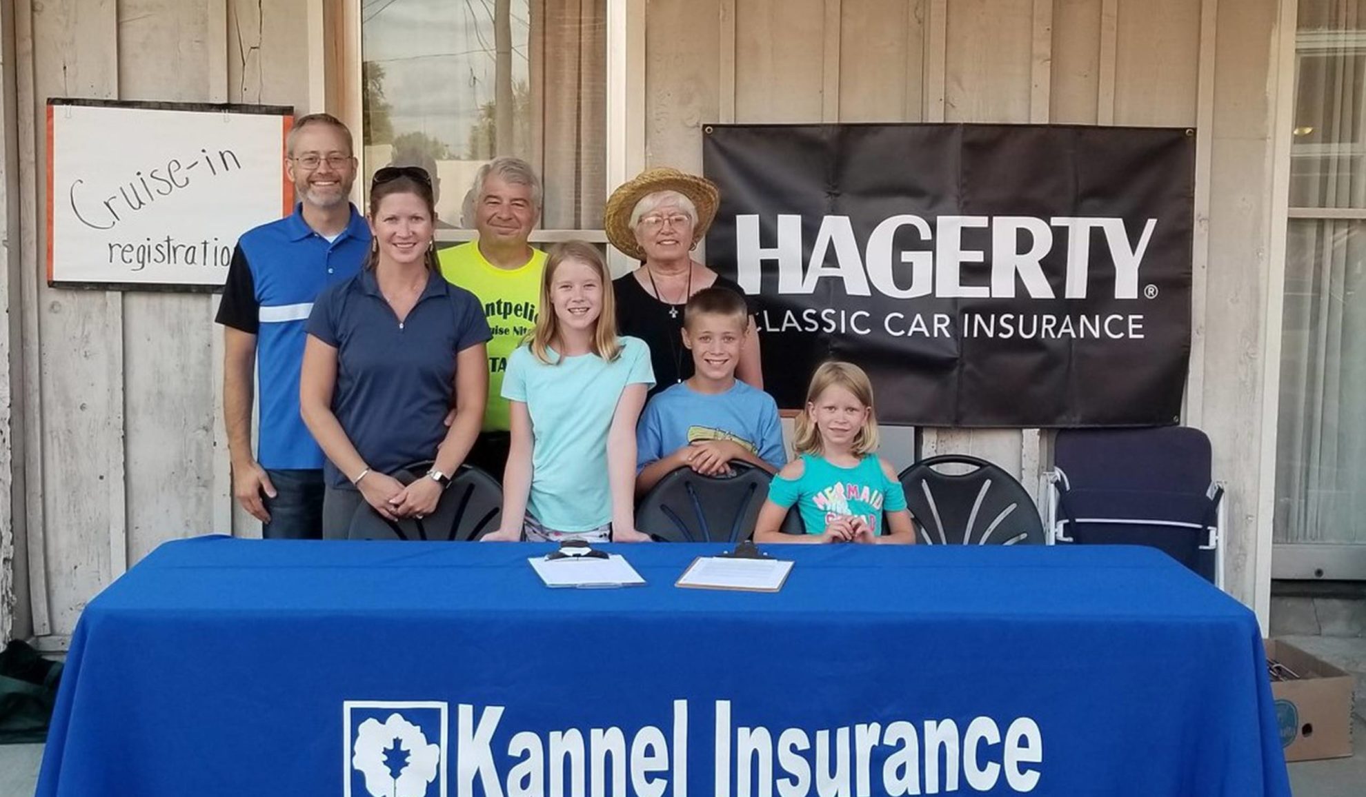 family posing behind event table montpelier oh