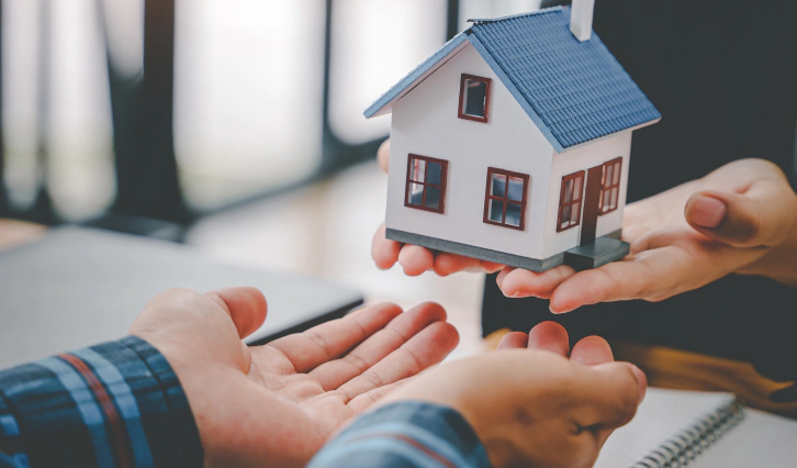 appraiser handing a client a small model of a house montpelier oh