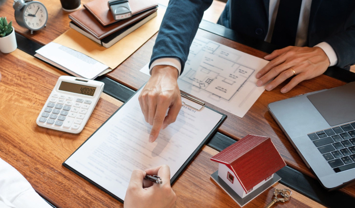 appraiser pointing at a document while client is signing papers montpelier oh