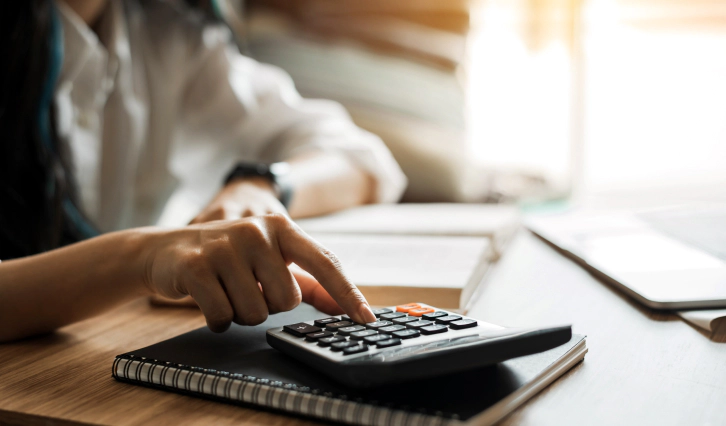 appraiser using the calculator on top of a book montpelier oh